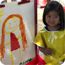 Child with painting in art class.