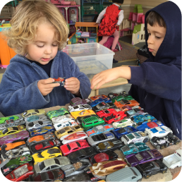 Children playing with colorful toy cars.
