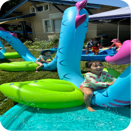 Children playing on inflatable water toys.