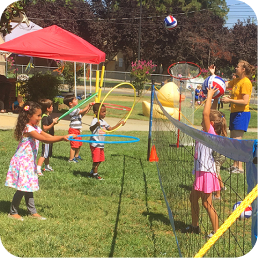 Children playing with hula hoops and balls.
