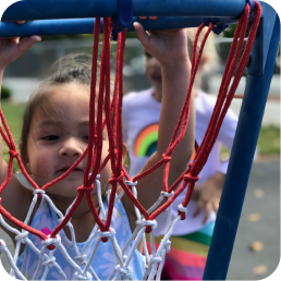 Smiling girl holding blue hoop frame