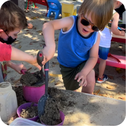 Children playing with sand at playground.