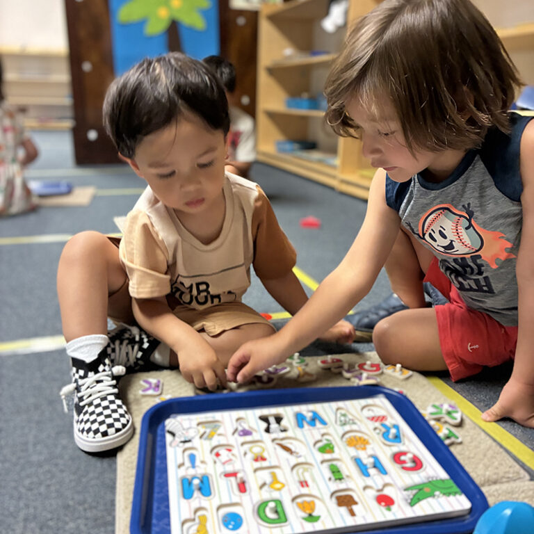 Children playing with alphabet puzzle together.